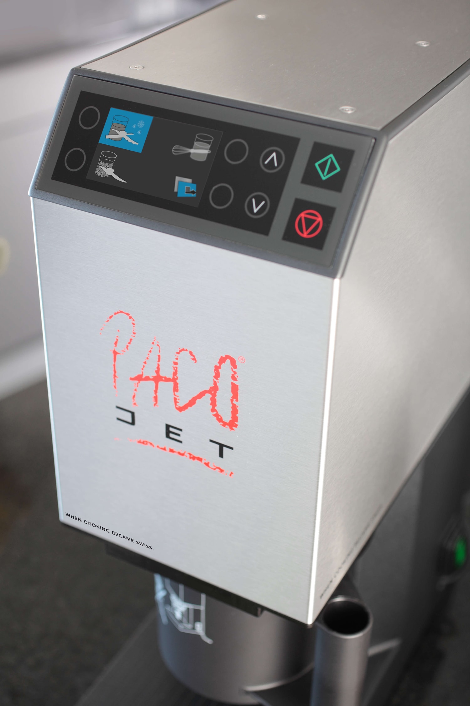 A stainless-steel Pacojet 2 photographed at close range, showing its control panel, housing, and beaker mount.