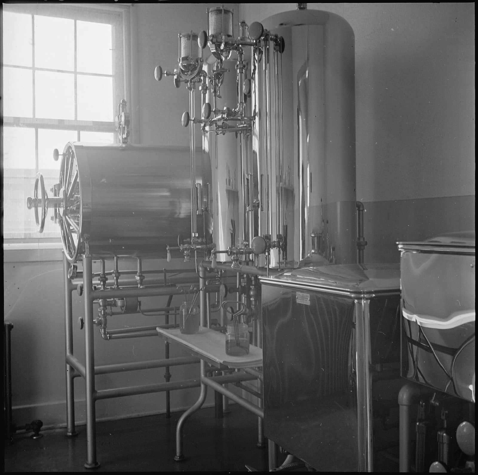Black-and-white archival photograph of autoclave tanks, gauges, valves, and piping at the Amache incarceration camp.