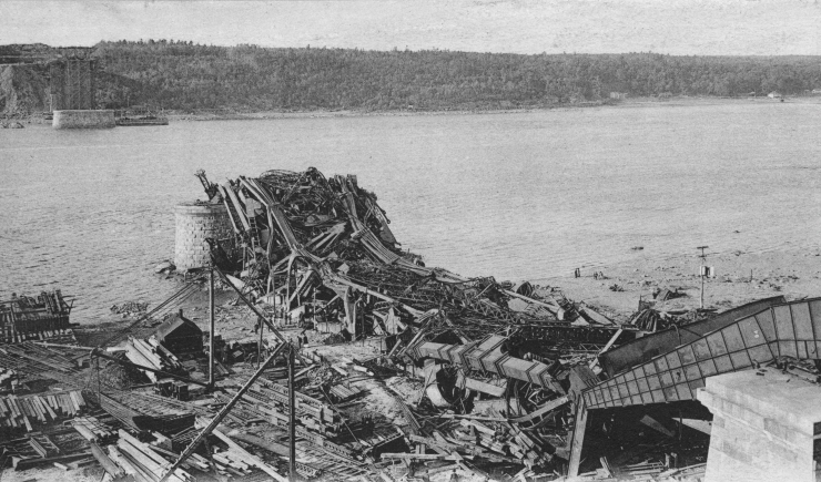 Archival photograph of the Quebec Bridge wreckage after the 1907 collapse, with twisted steel trusses fallen near the St. Lawrence River.
