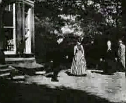 Archival still from Roundhay Garden Scene showing four figures in a garden at Oakwood Grange in Leeds in 1888.
