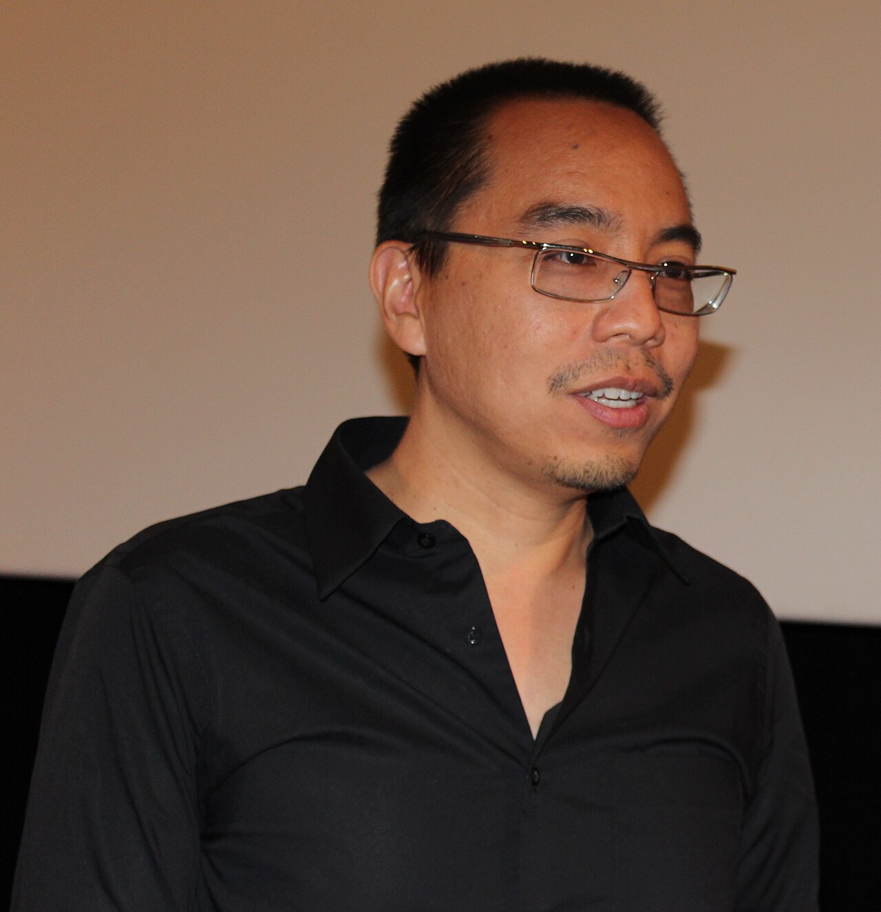 Filmmaker Apichatpong Weerasethakul looks toward the camera at the Côté Court short-film festival in Pantin, France, in 2012.