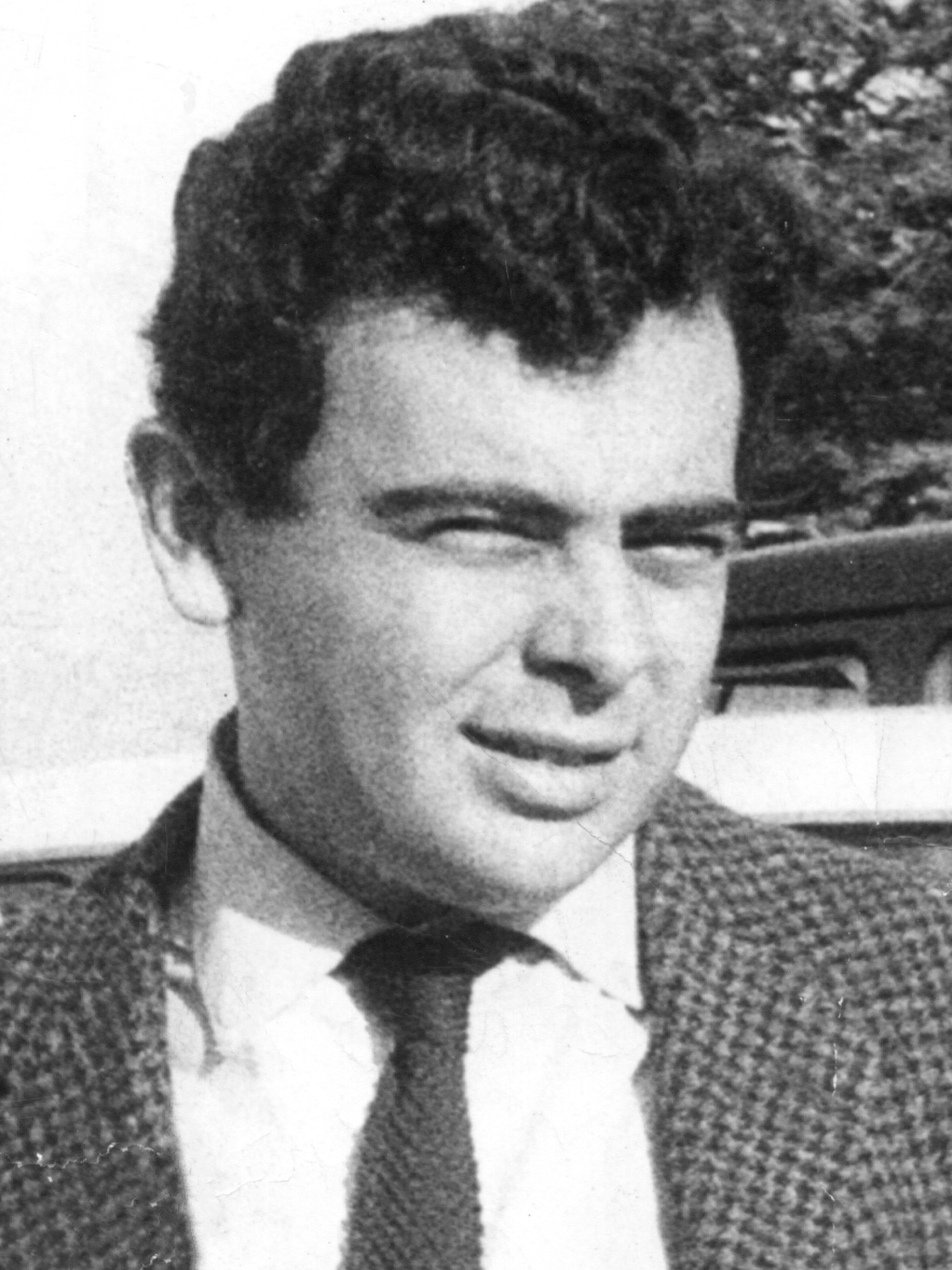 Black-and-white archival portrait of a young Glauber Rocha in a jacket and tie, looking slightly to the side.