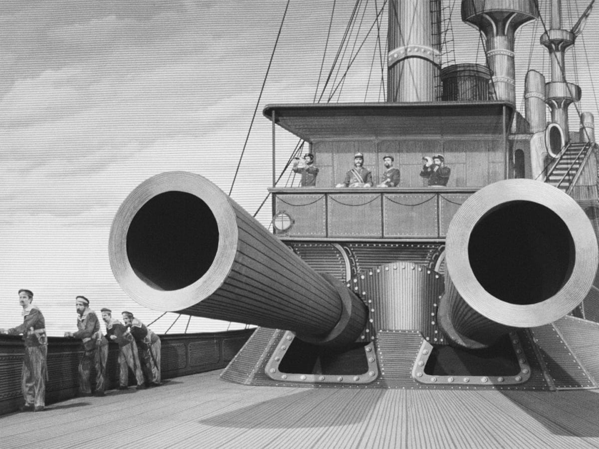Black-and-white film still of sailors standing around two enormous cannons on a warship whose deck, machinery, sky, and costumes are covered in engraved linework.