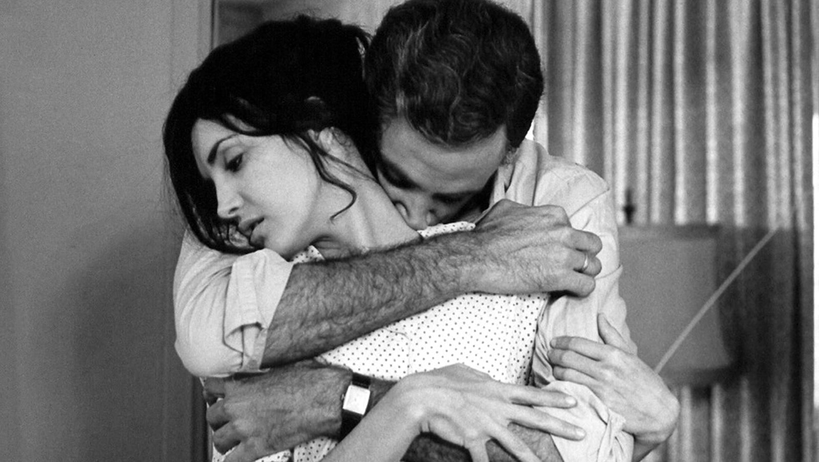 Sergio wraps both arms around Elena in a black-and-white scene from Memories of Underdevelopment.