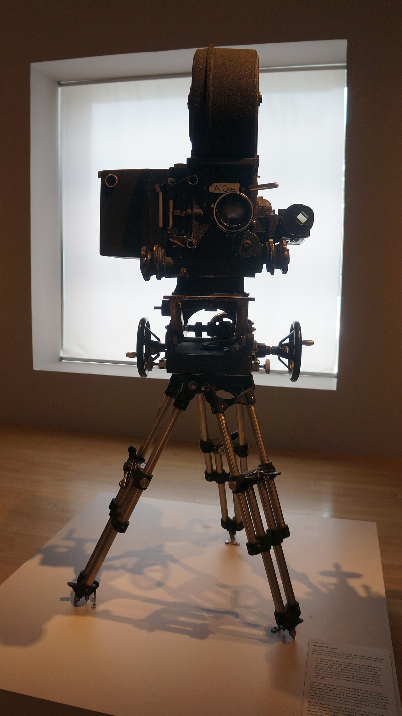 A photographed Mitchell BNC motion-picture camera on a tripod, displayed in the Stanley Kubrick exhibition at LACMA.