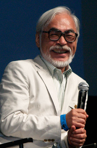 Hayao Miyazaki speaking into a microphone at San Diego Comic-Con in 2009.