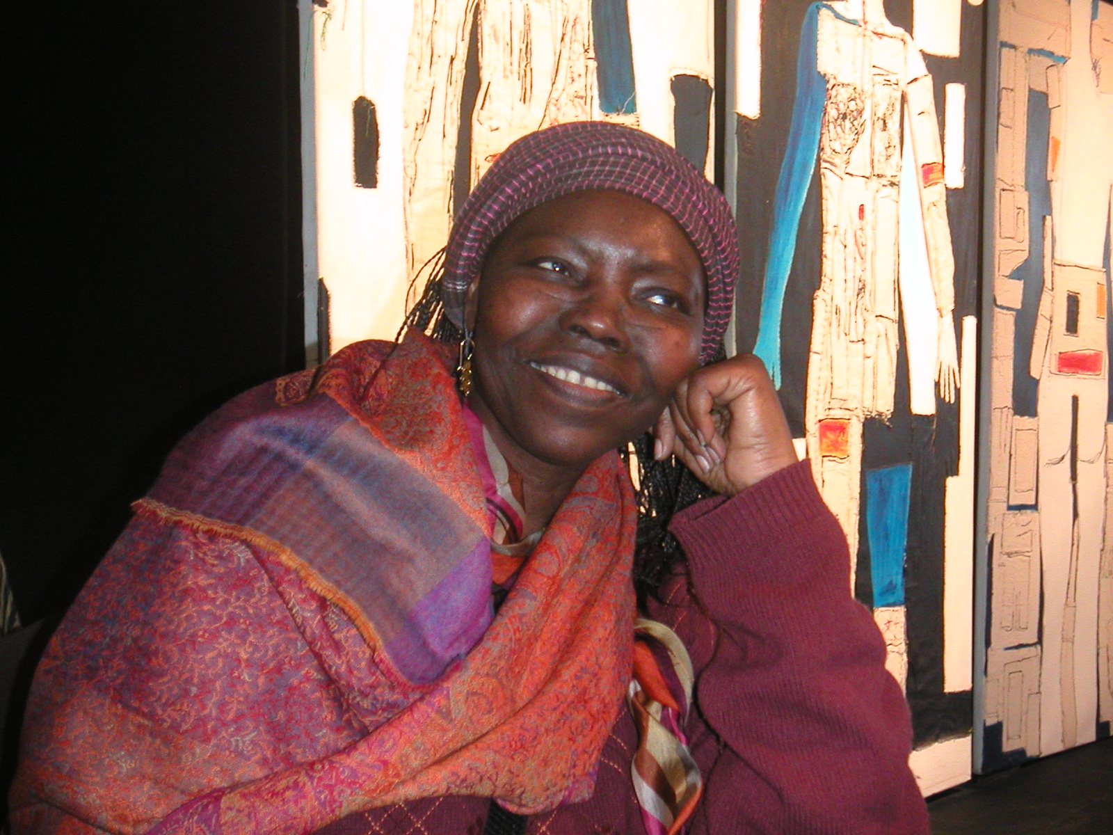 Senegalese filmmaker Safi Faye smiles with her chin resting on one hand at an African film festival in Apt, France.