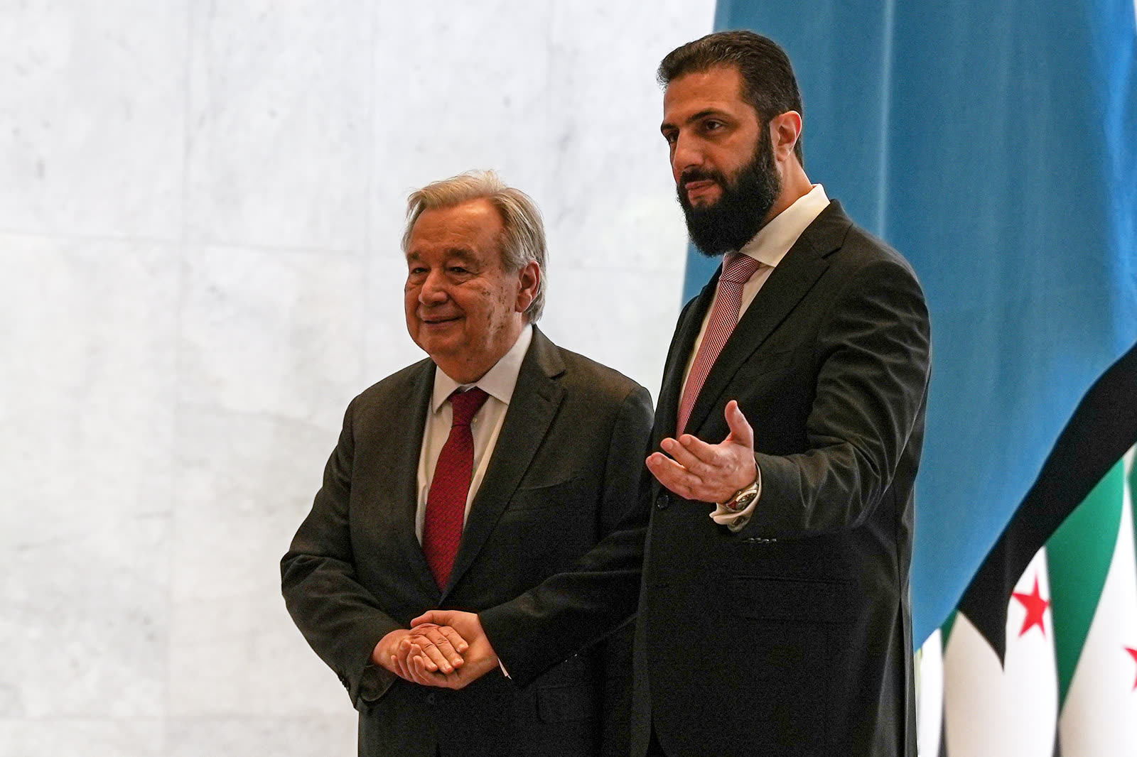 UN Secretary-General António Guterres stands beside Syrian interim President Ahmad al-Sharaa at the presidential palace in Damascus.