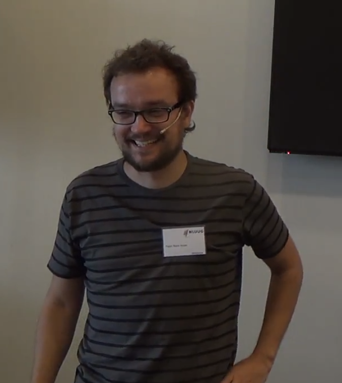 Pablo Neira Ayuso smiles while wearing a headset microphone and NLUUG name badge at a 2016 nftables workshop.