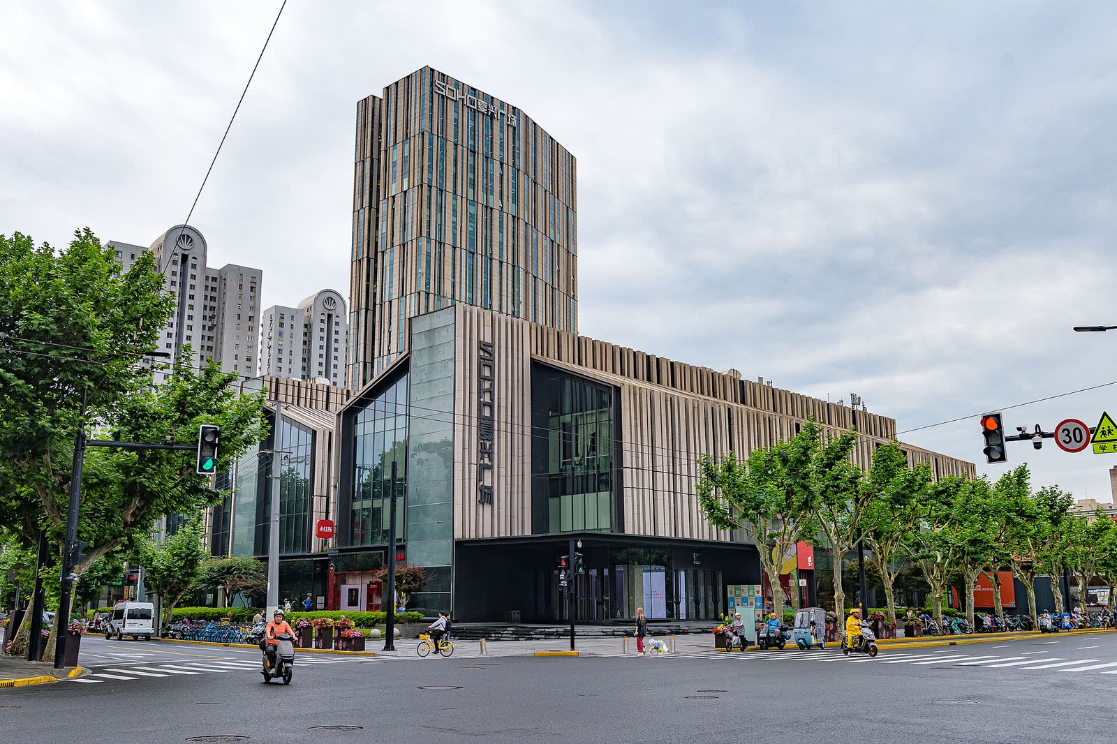 A street-level view of SOHO Fuxing Plaza's rectilinear tan-and-glass tower and low podium in Shanghai, where Xiaohongshu is headquartered.