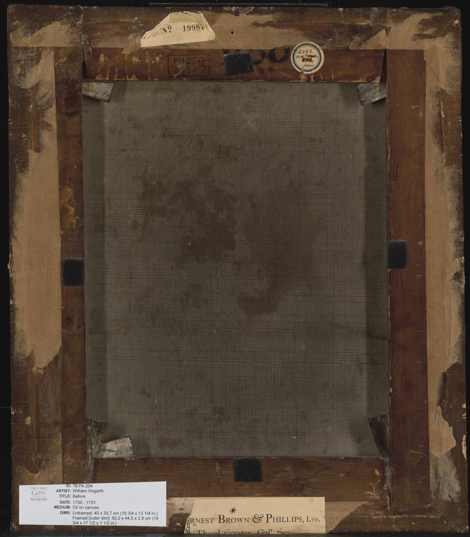 The worn reverse of William Hogarth's Before, with exposed canvas, wooden supports, metal tabs, inked numbers, and old paper labels.