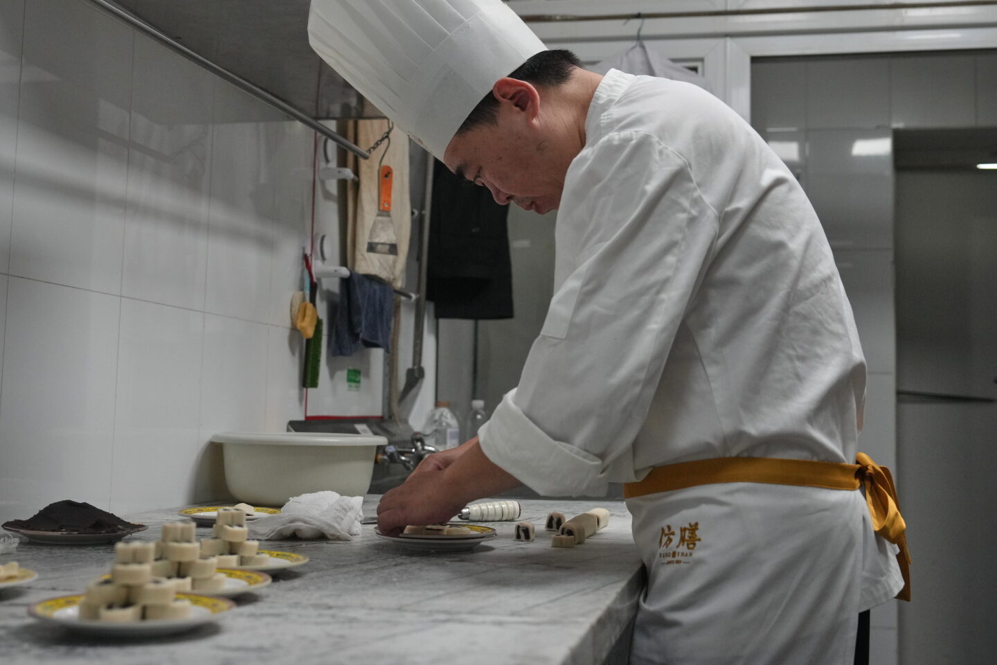 Chef Zhou Tong shapes red bean rolls by hand in the Fangshan Restaurant kitchen in Beijing.