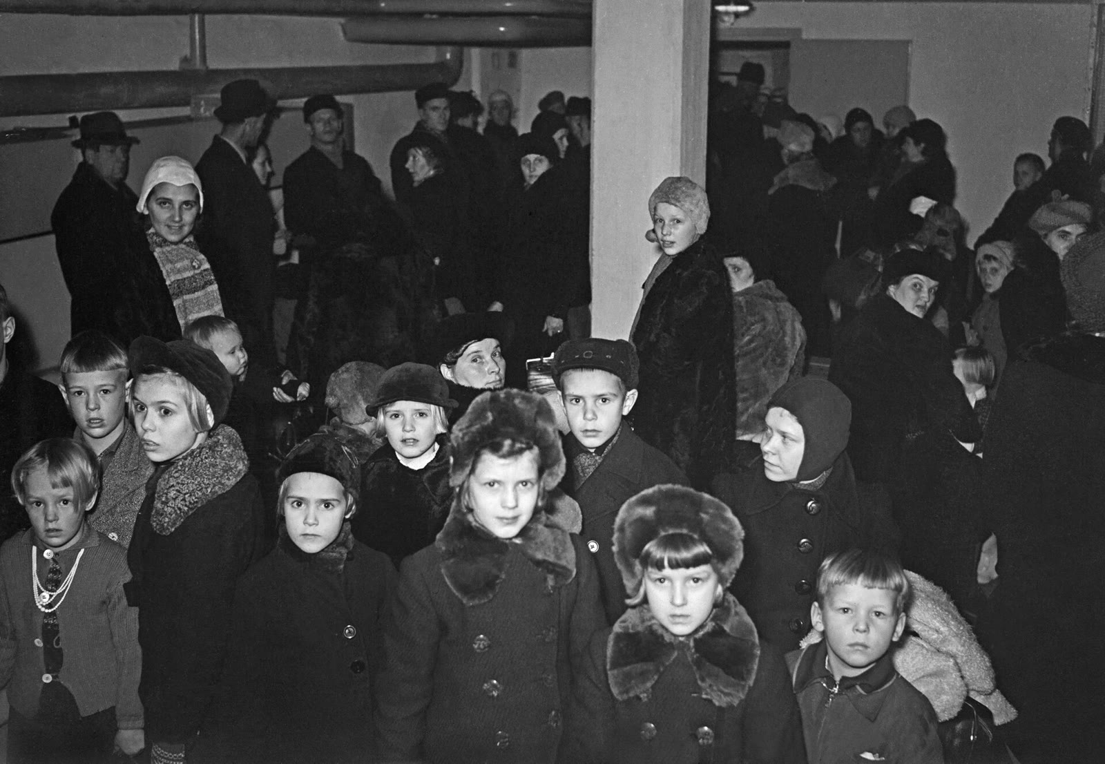 Finnish children in winter coats waiting to depart for Sweden on 30 December 1939.
