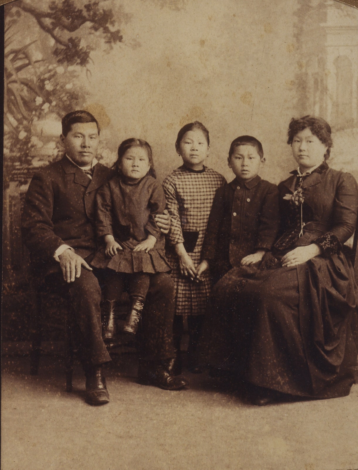 An 1884–85 studio portrait of Joseph Tape seated at left with Emily on his knee, Mamie and Frank standing in the center, and Mary Tape seated at right.