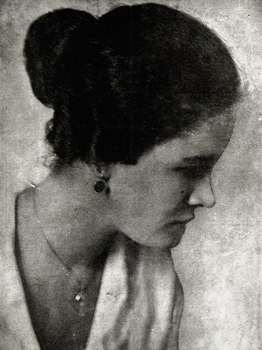 Black-and-white 1920 profile portrait of Georgia Douglas Johnson, with her hair swept back and her gaze lowered.