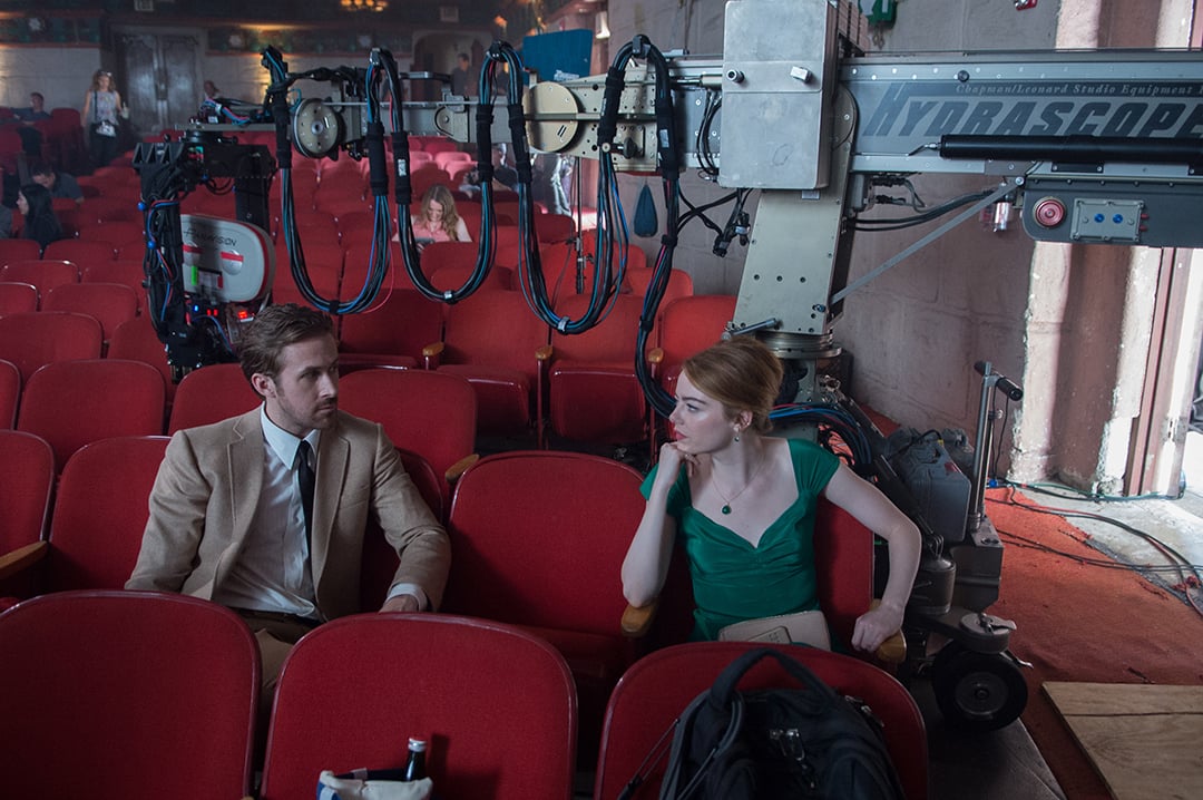 A film camera on a telescopic crane records Ryan Gosling and Emma Stone during production of La La Land.