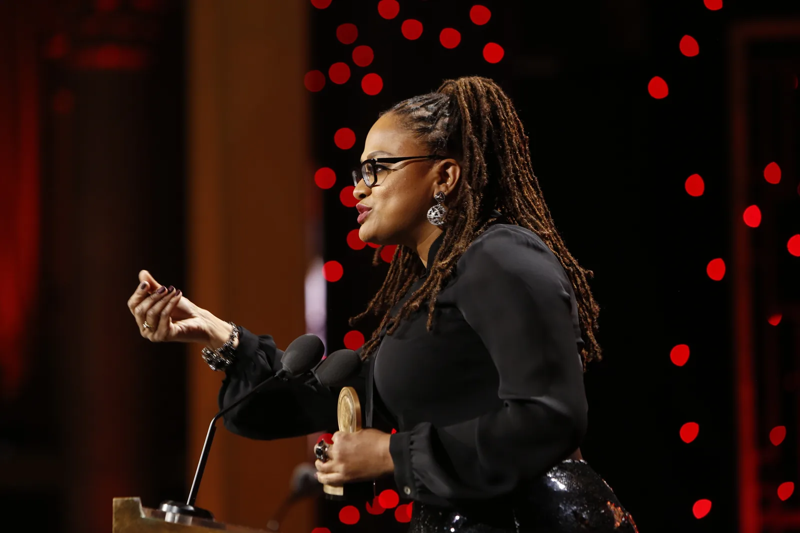 Ava DuVernay speaks at a podium while accepting a Peabody Award for the documentary 13th in 2017.