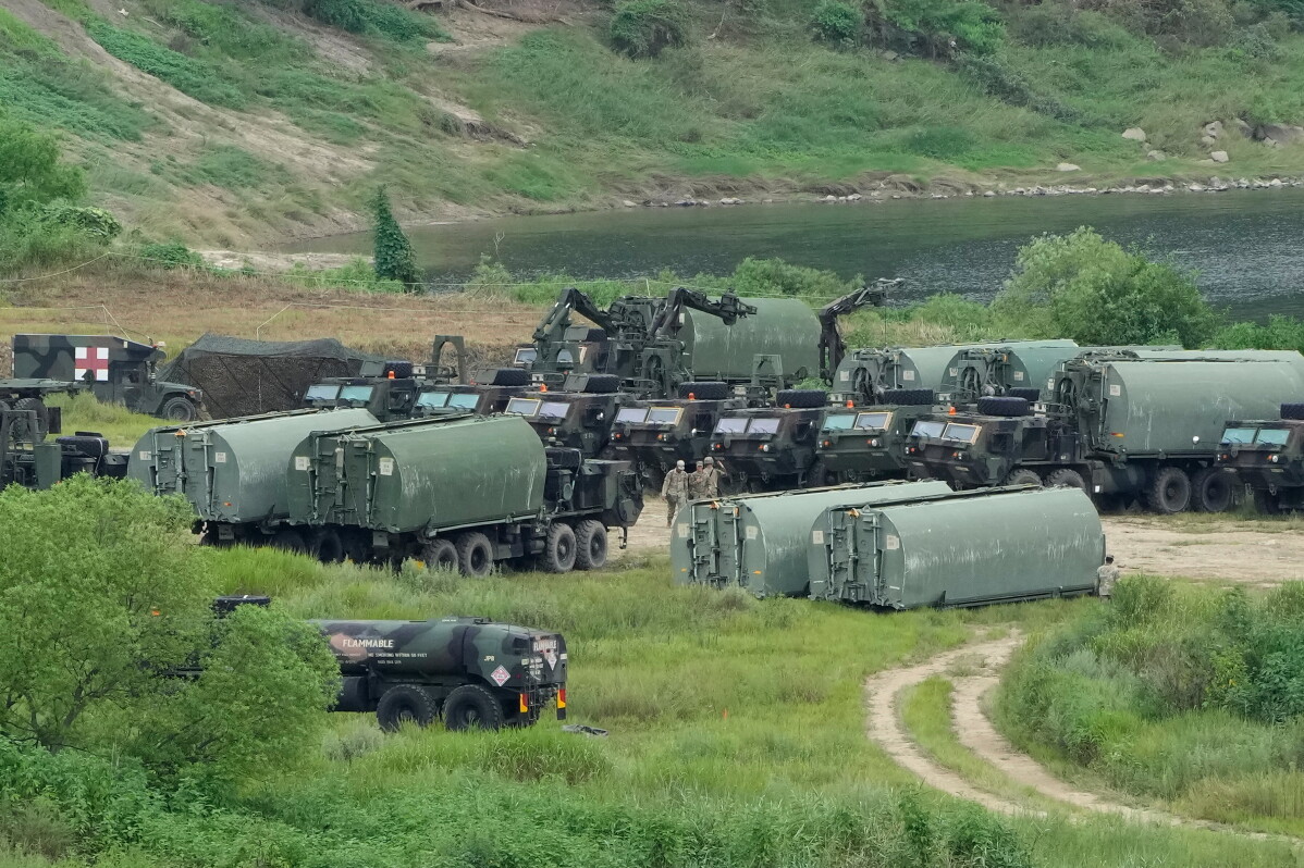U.S. Army armored vehicles assembled on grass before a river crossing near Yeoncheon, South Korea.