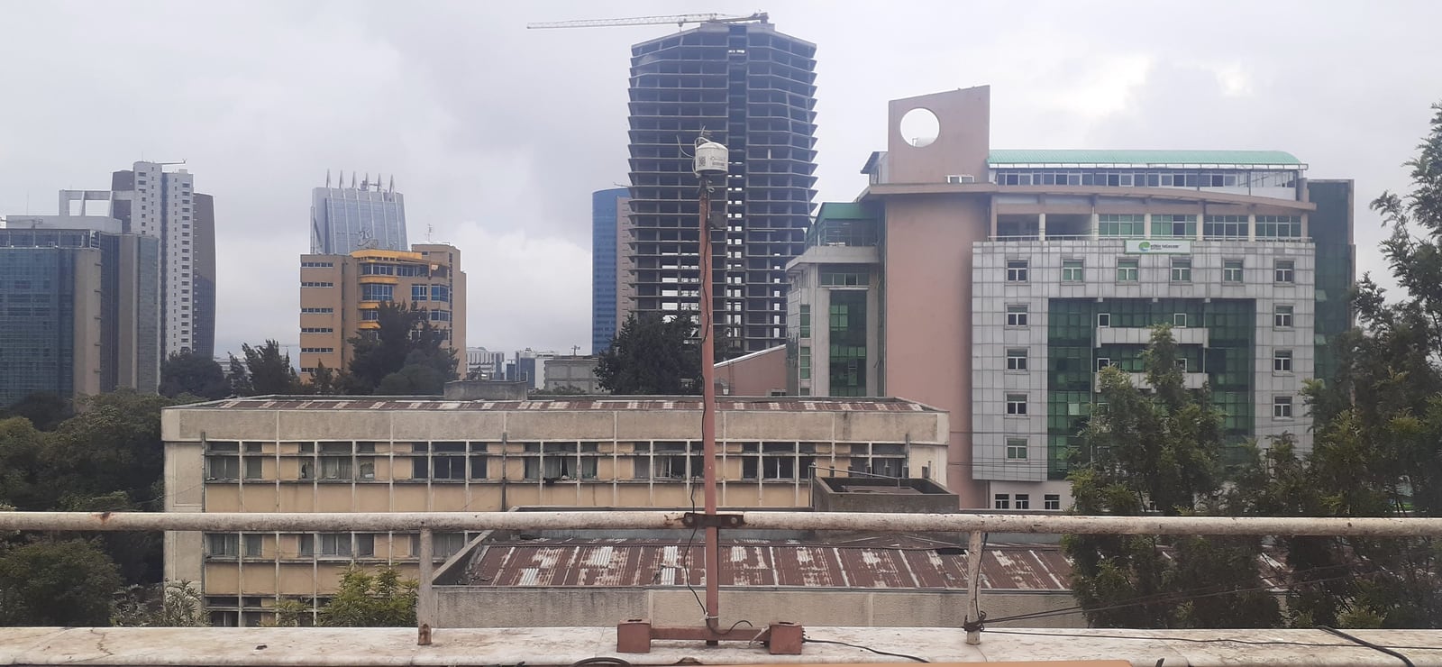 A roof-mounted air-quality sensor overlooks a dense neighborhood in Addis Ababa, Ethiopia.