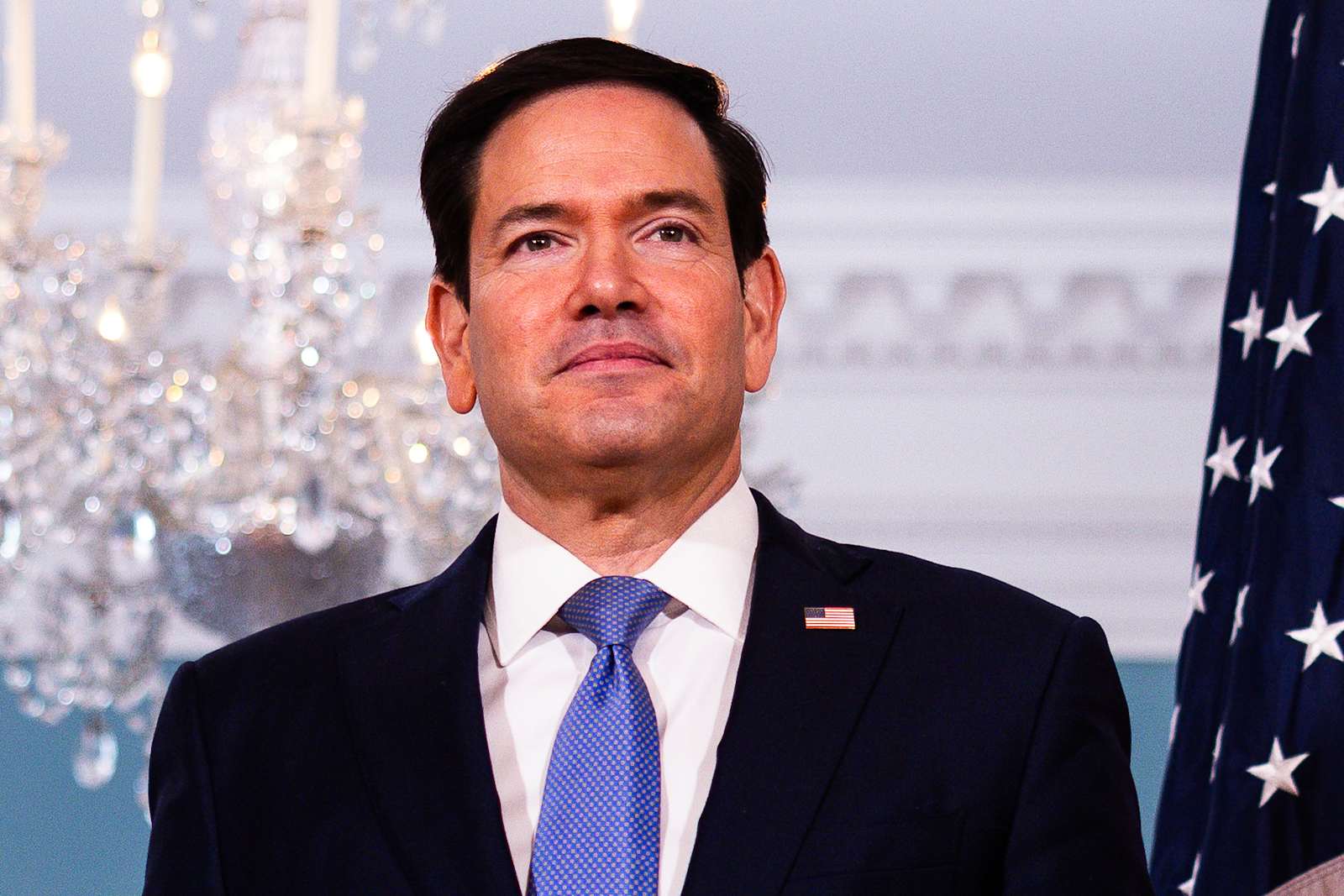 U.S. Secretary of State Marco Rubio stands beside an American flag in the Treaty Room at the State Department in Washington.