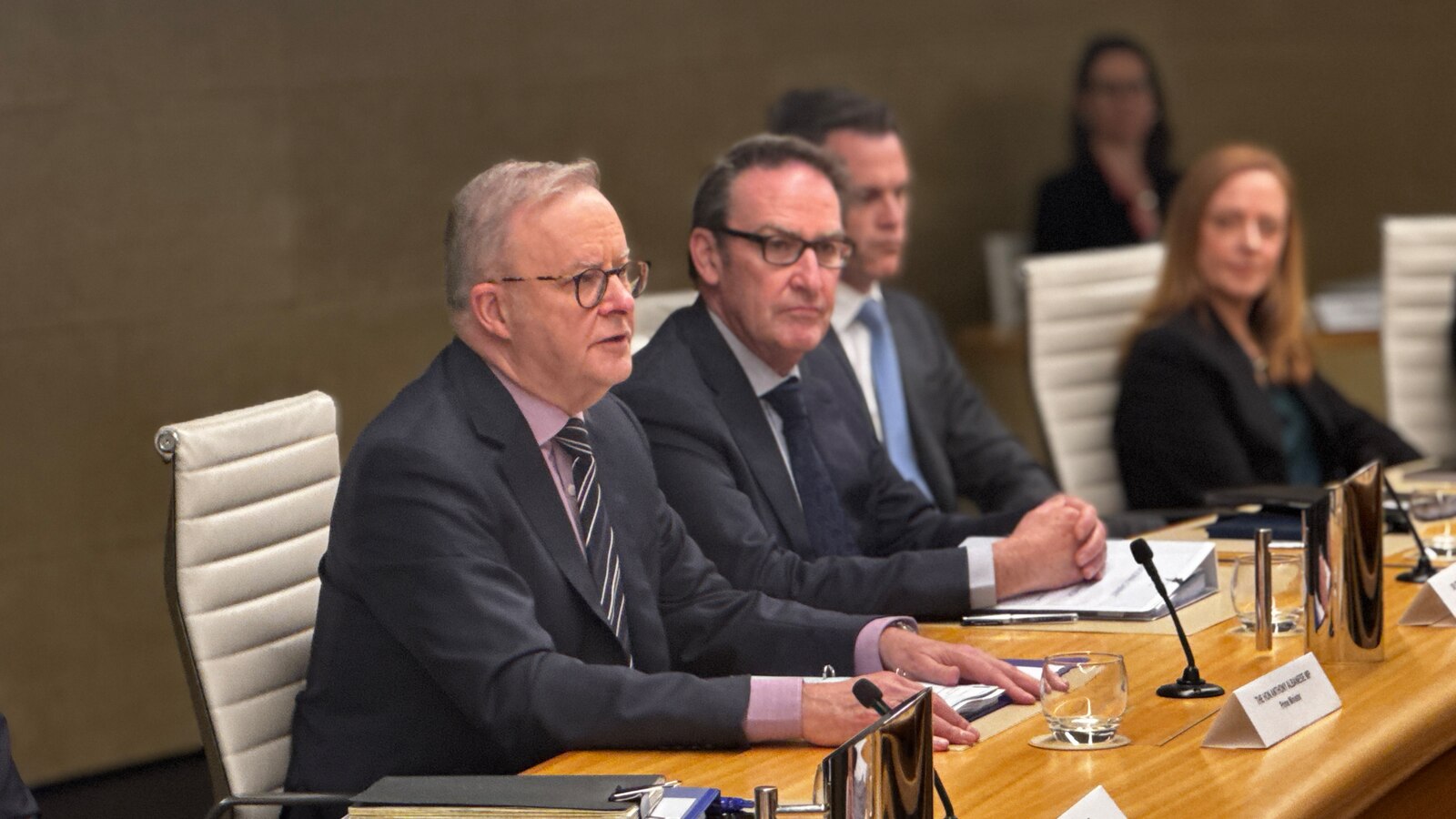 Australian Prime Minister Anthony Albanese sits at an oval table during the National Cabinet meeting in Sydney.