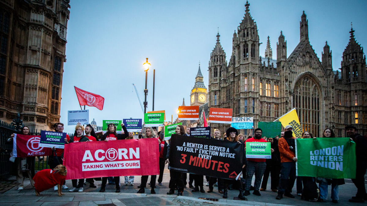 Renters’ Reform Coalition campaigners hold banners outside Parliament calling for an end to unfair evictions.