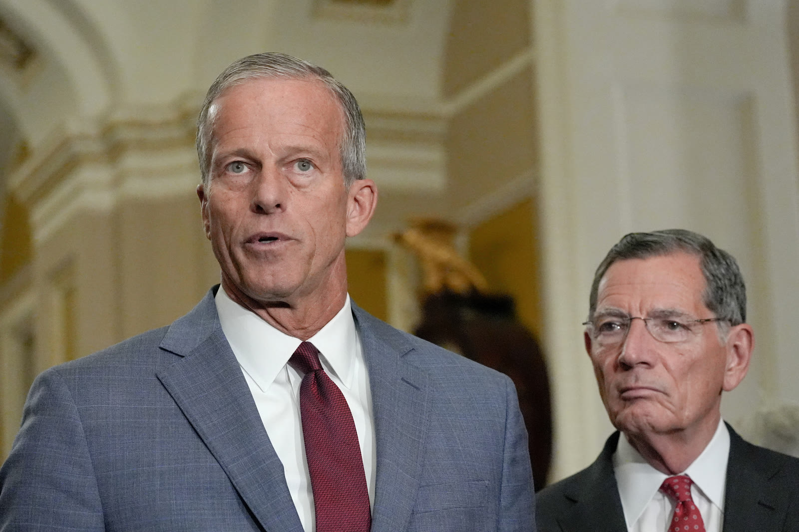 Senate Majority Leader John Thune speaks at a Capitol Hill news conference beside Senator John Barrasso.