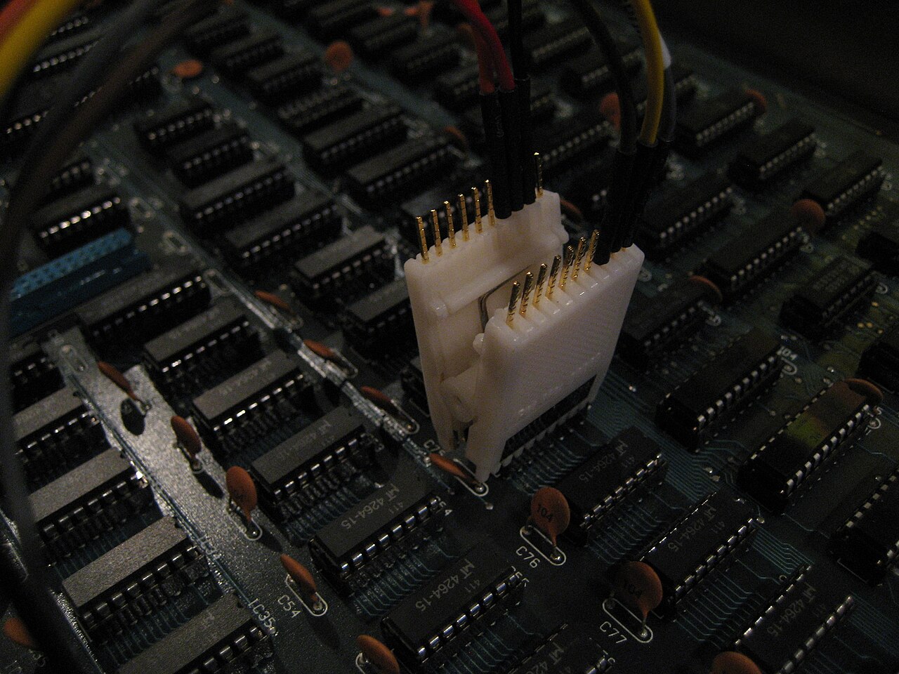 Multicolored logic-analyzer probe leads clipped to memory chips on an E-mu Emulator II circuit board.