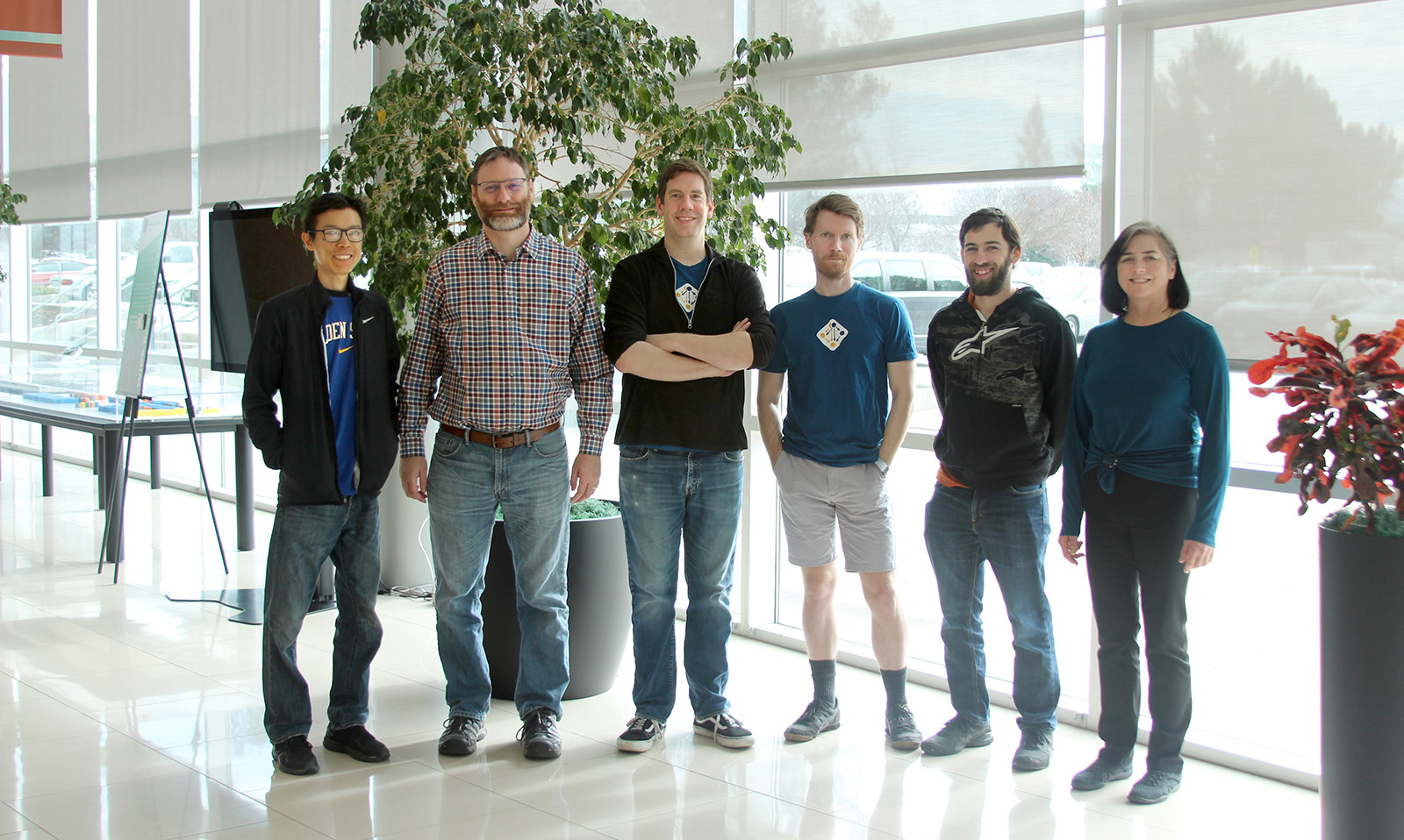 Six members of the Spack development team stand side by side in a bright Lawrence Livermore National Laboratory room.