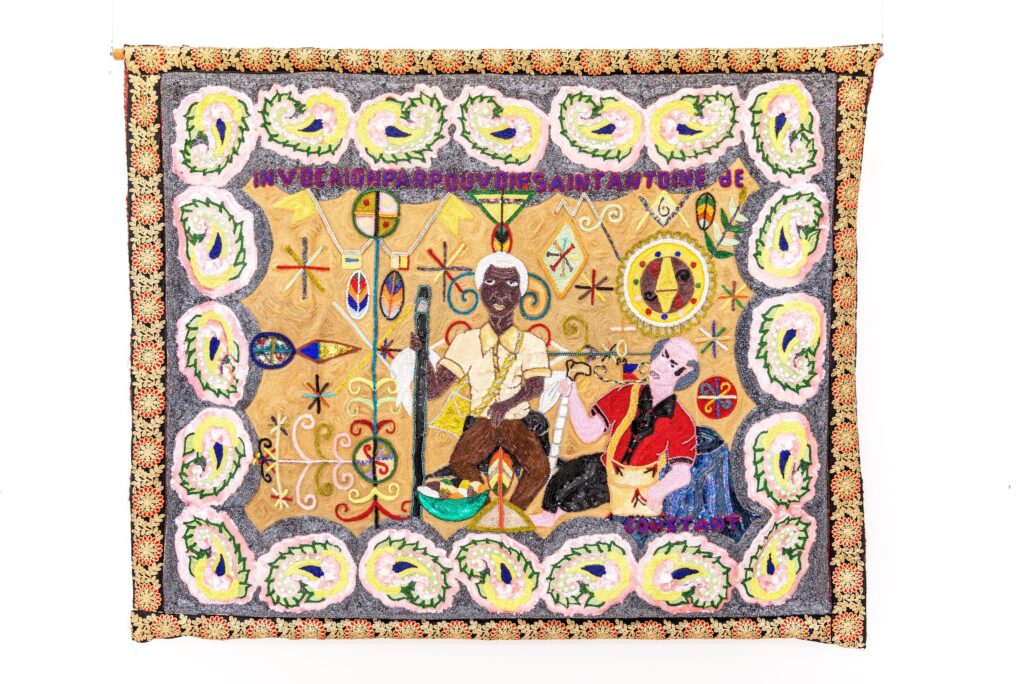 Myrlande Constant's Invocation for Saint Anthony, a densely beaded textile with two central seated figures, patterned symbols, and a multicolored border.