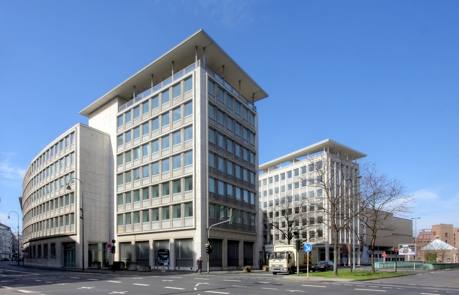 科隆赫斯塔特银行旧址，建筑临近十字路口，弧形外立面由石材面板与窗户组成。