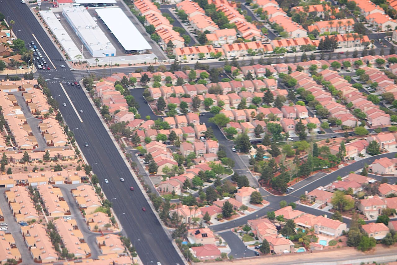 An aerial photograph of closely spaced suburban homes and residential streets in Las Vegas, Nevada.
