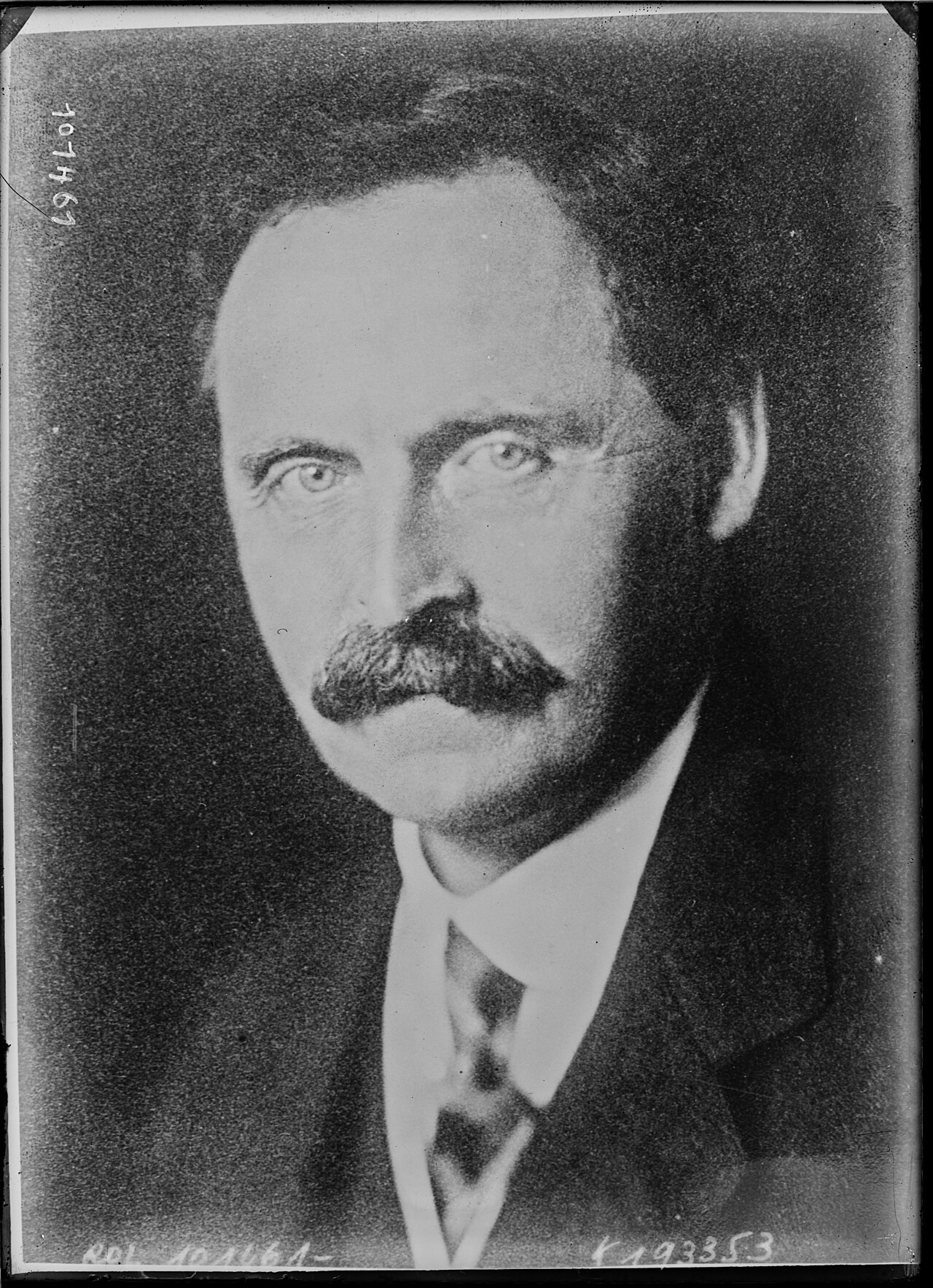 Frontal head-and-shoulders portrait of Lord Dawson of Penn in a dark suit and striped tie in a 1925 black-and-white press photograph.