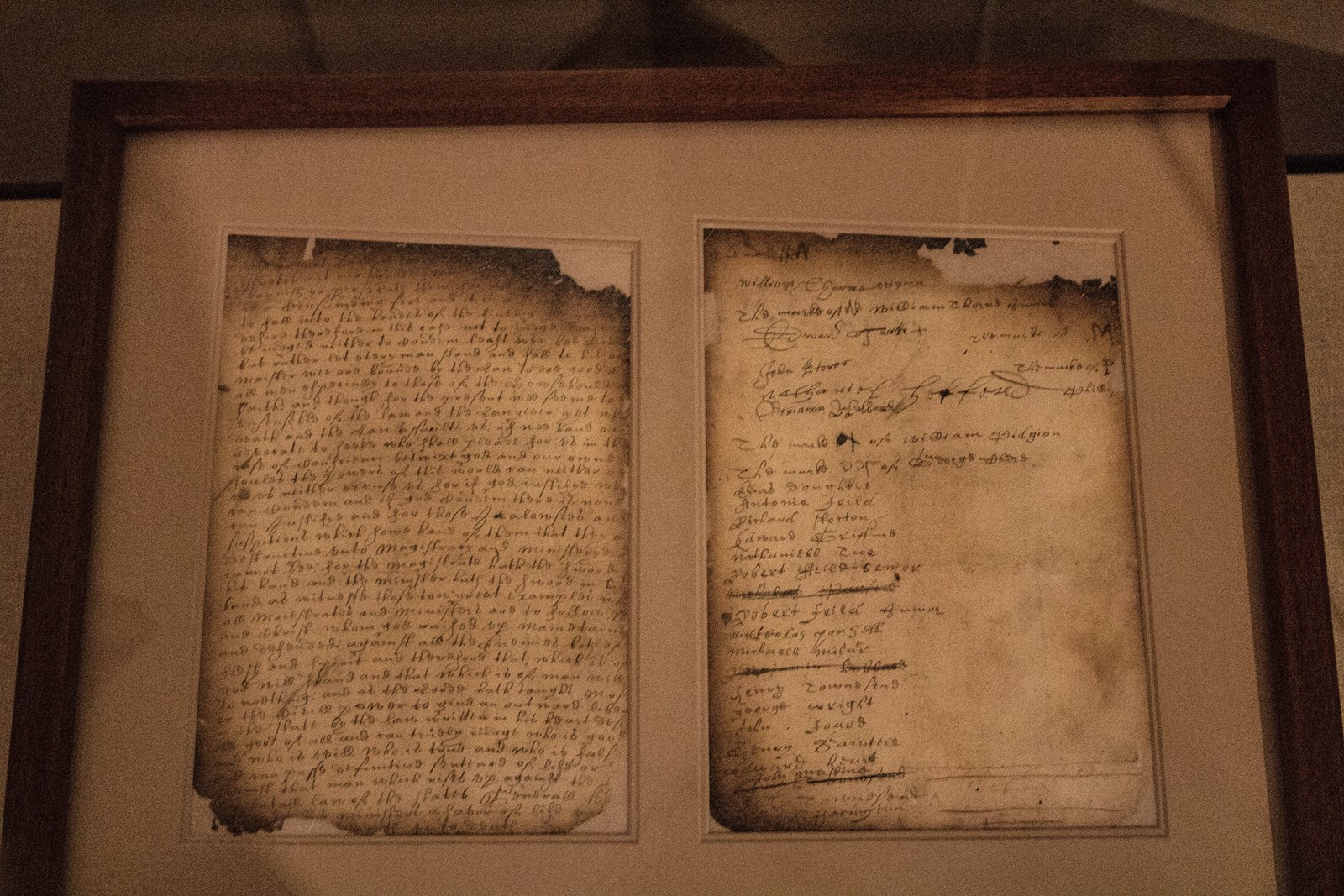 Two surviving pages of the handwritten Flushing Remonstrance, with darkened, irregular edges from the 1911 New York State Capitol fire.