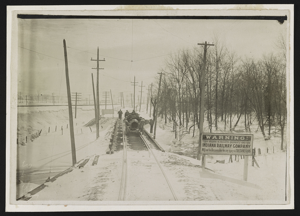 The Thomas Flyer automobile on a railway bridge in snowy Indiana during the 1908 New York-to-Paris race.