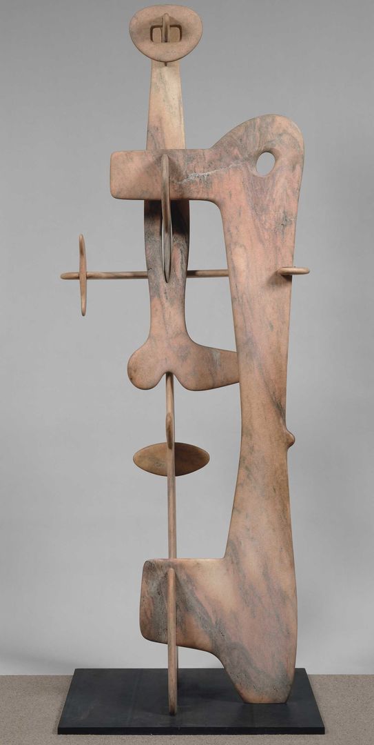 Isamu Noguchi’s tall pink marble Kouros, assembled from curved, interlocking slabs with open spaces between its upright elements.