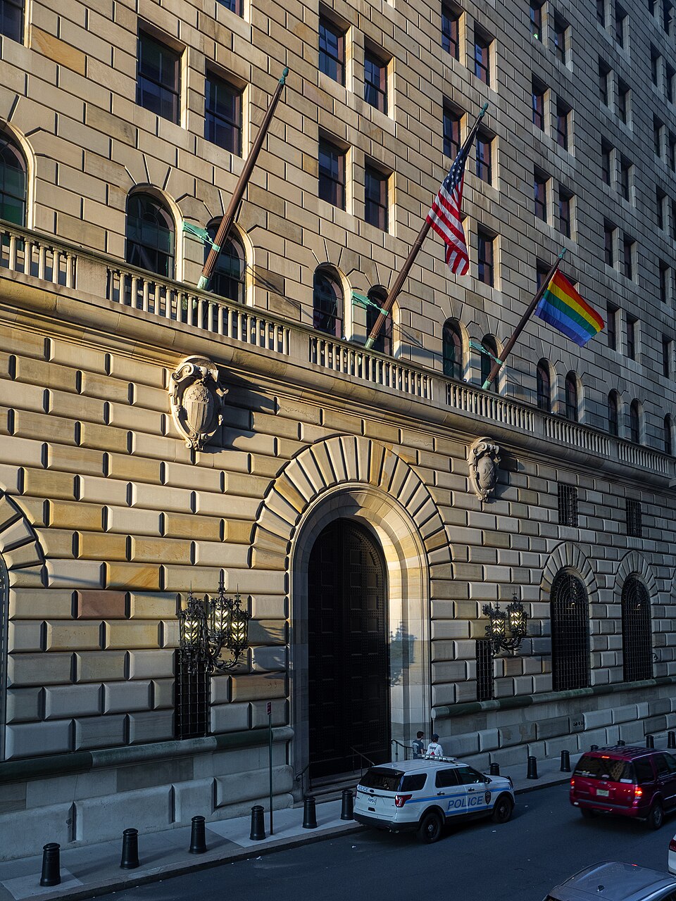 The arched entrance to the Federal Reserve Bank of New York, surrounded by rusticated stonework and ornate ironwork.