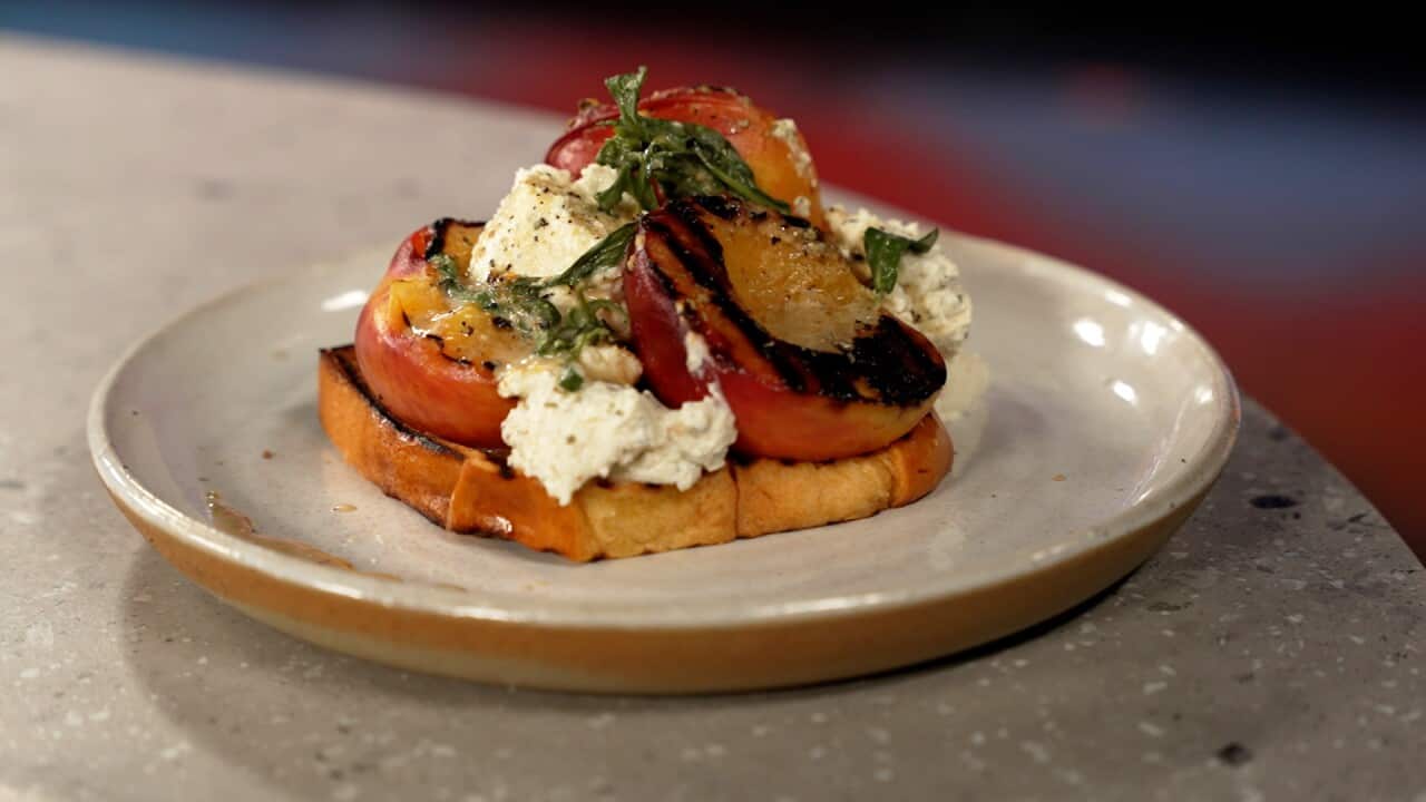 Nornie Bero's charred peaches with wattleseed ricotta and pepperberry seasoning, served on brioche.