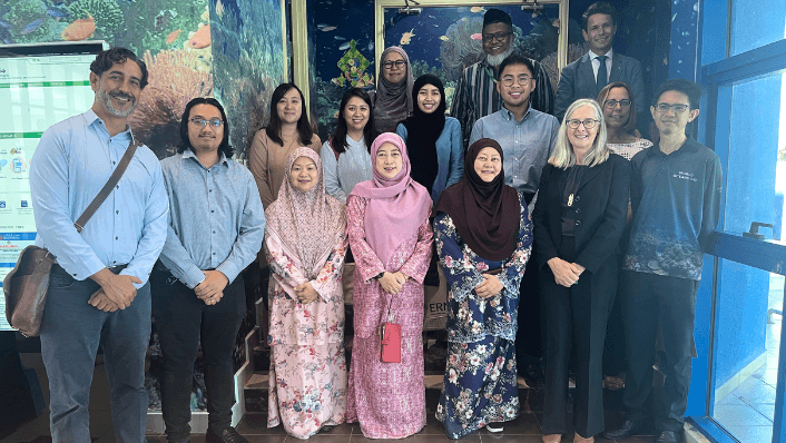 Participants pose in front of reef displays at the launch of Brunei’s National Coral Reef Monitoring and Management Plan.